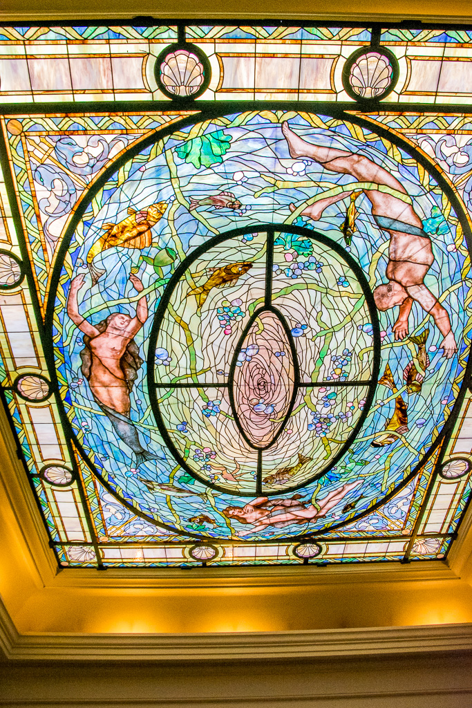 The large domed skylight contains 8,000 pieces of glass, arranged to represent Nepturn's daughter, mermaids, dophins, and fish in swirling water.