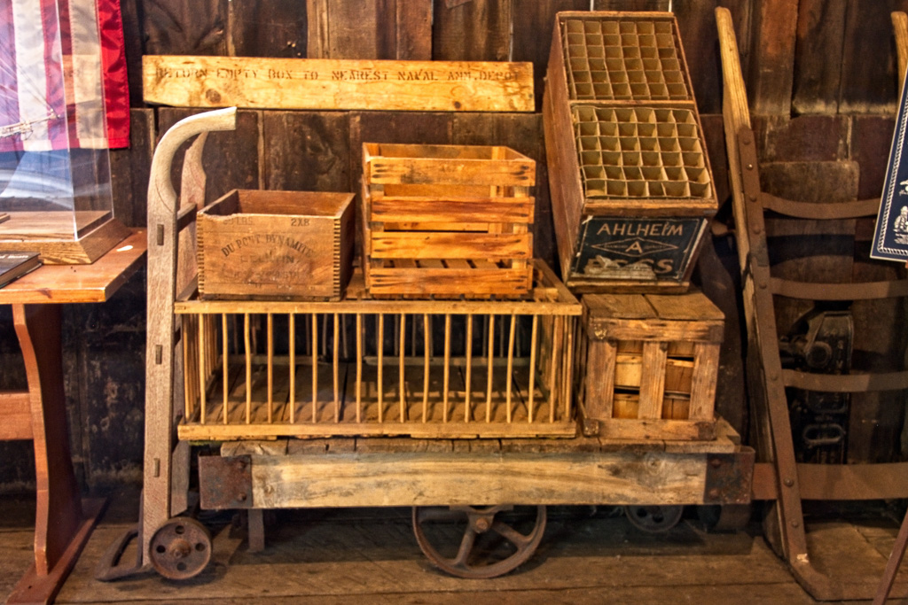 Chicken carrier, egg crate, apple crate, dynamite box on trolley.