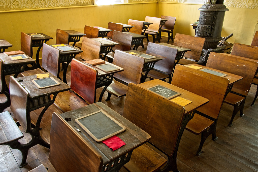Schoolhouse desks with slate tablets. Paper was too expensive.